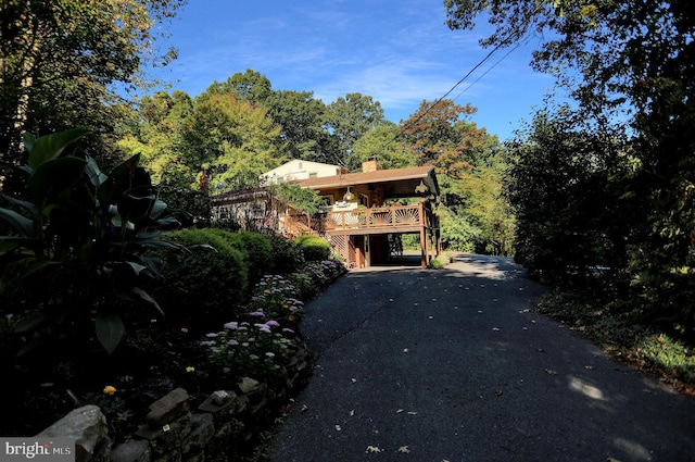 650 Bucks Church Rd, Newport, PA 17074 - view of property hidden behind natural elements with a chimney, driveway, a deck, and a carport