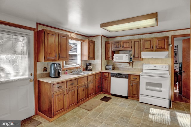 650 Bucks Church Rd, Newport, PA 17074 - kitchen with white appliances, under cabinet range hood, a sink, and brown cabinets