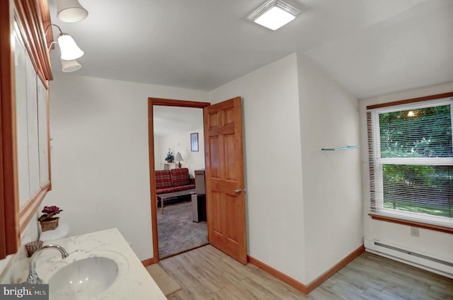 650 Bucks Church Rd, Newport, PA 17074 - bathroom with baseboard heating, wood finished floors, vanity, and baseboards