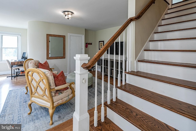 stairway with hardwood / wood-style flooring