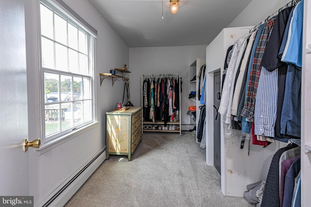 spacious closet featuring a baseboard radiator and light colored carpet