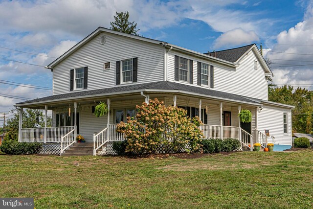 back of property featuring a yard, a playground, and covered porch