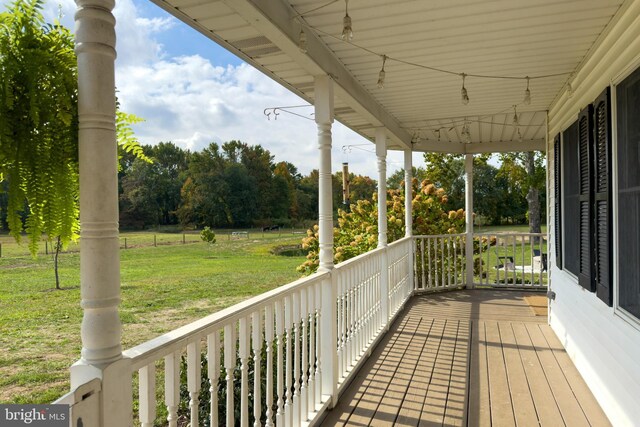 wooden deck featuring a yard and a water view