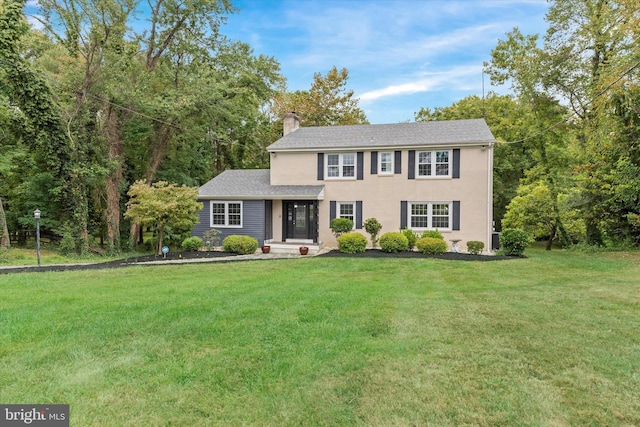 colonial-style house with a front yard