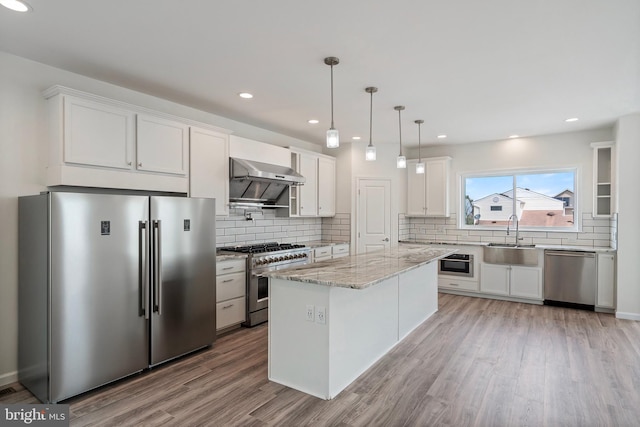 kitchen featuring light wood-type flooring, sink, white cabinets, exhaust hood, and appliances with stainless steel finishes