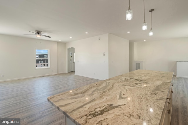 kitchen featuring pendant lighting, wood-type flooring, and ceiling fan