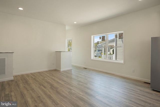 unfurnished living room with wood-type flooring