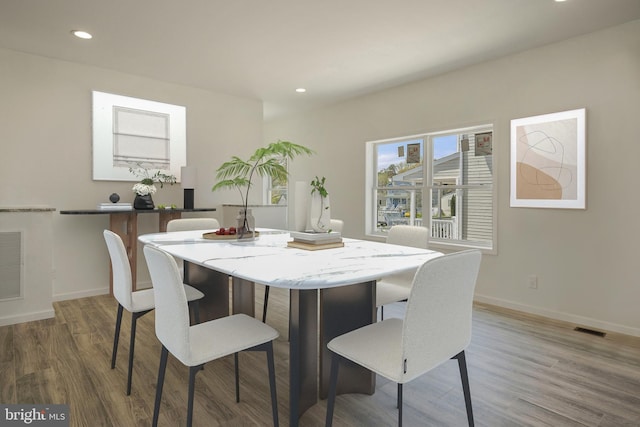 dining area with hardwood / wood-style floors