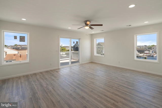 unfurnished room with dark wood-type flooring and ceiling fan