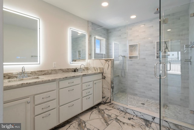 bathroom featuring vanity and an enclosed shower