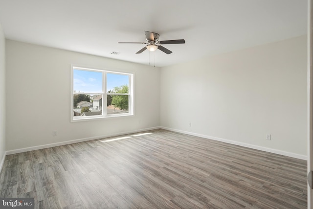 empty room with ceiling fan and hardwood / wood-style floors