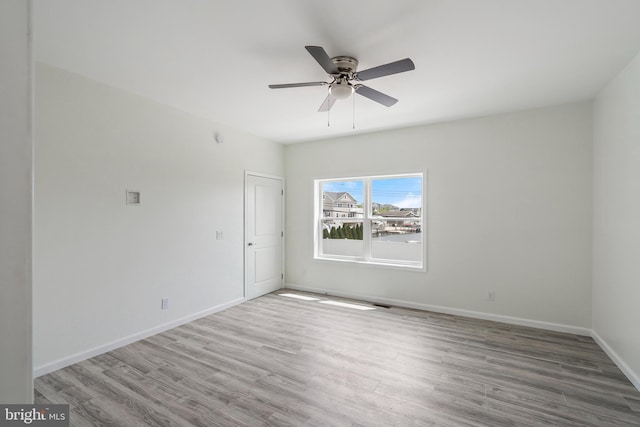 unfurnished room with ceiling fan and hardwood / wood-style floors