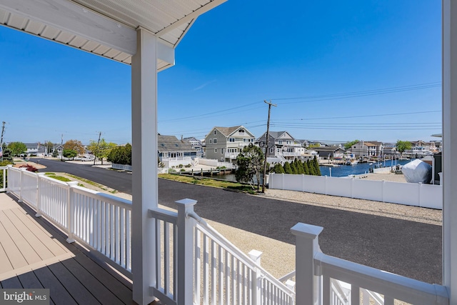 wooden deck featuring a water view