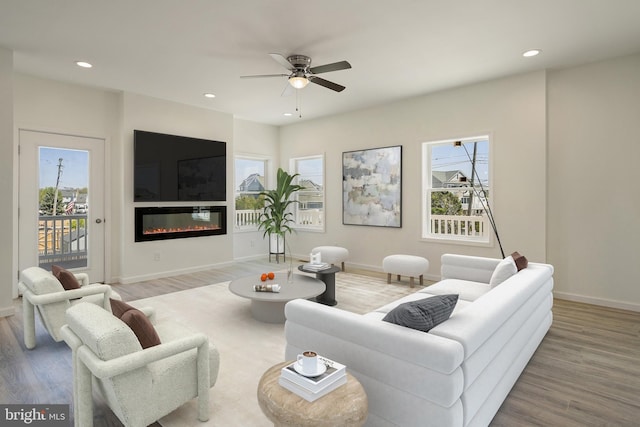 living room with wood-type flooring and ceiling fan