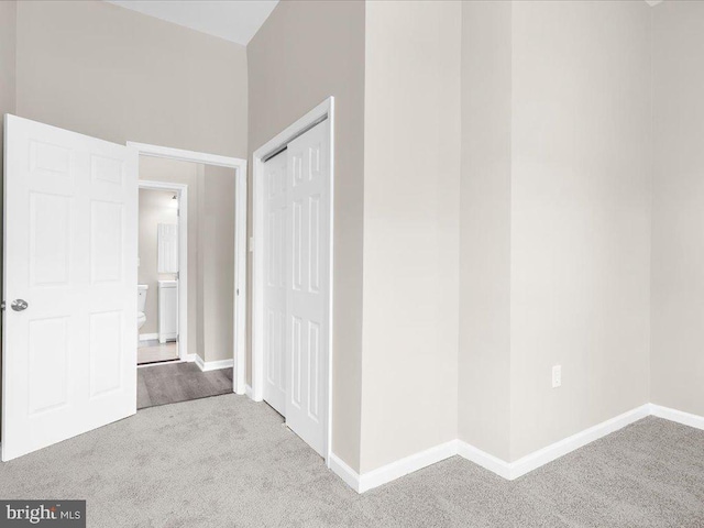 hall featuring light colored carpet