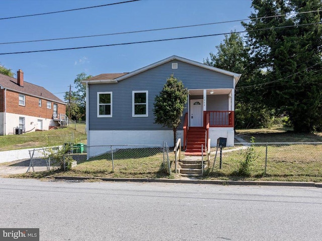 view of front of property featuring cooling unit, a front yard, and a porch