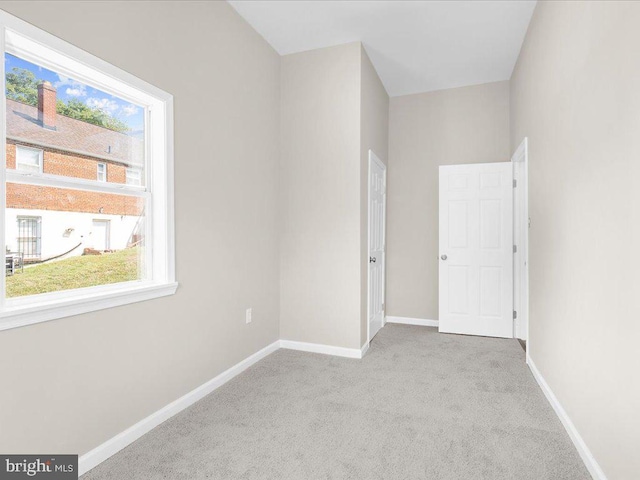 unfurnished bedroom with light colored carpet