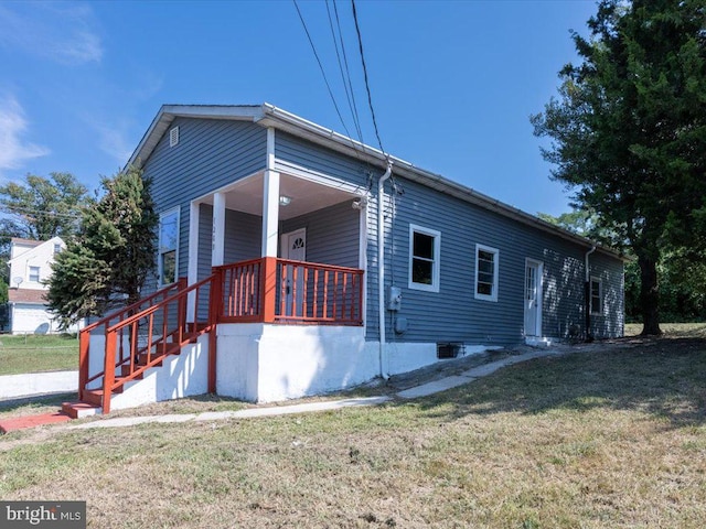 view of property exterior with a lawn