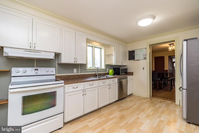 kitchen featuring ornamental molding, sink, white cabinetry, stainless steel appliances, and light hardwood / wood-style floors