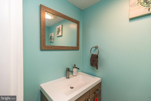 bathroom featuring a textured ceiling and vanity