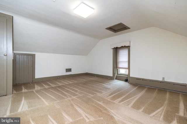 bonus room with carpet, lofted ceiling, and a baseboard heating unit