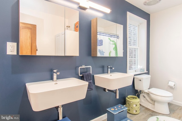 bathroom featuring hardwood / wood-style flooring, sink, and toilet