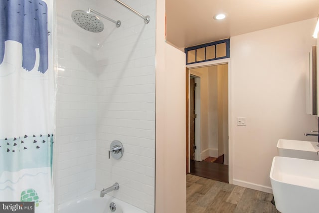 bathroom featuring wood-type flooring, shower / bath combo, and vanity