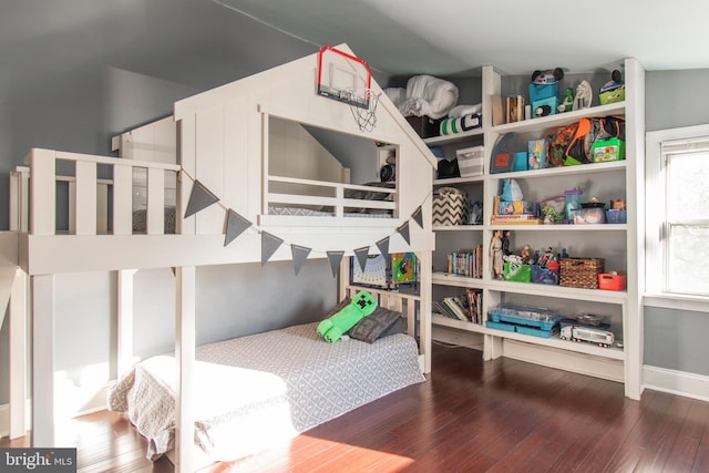 bedroom with dark hardwood / wood-style floors