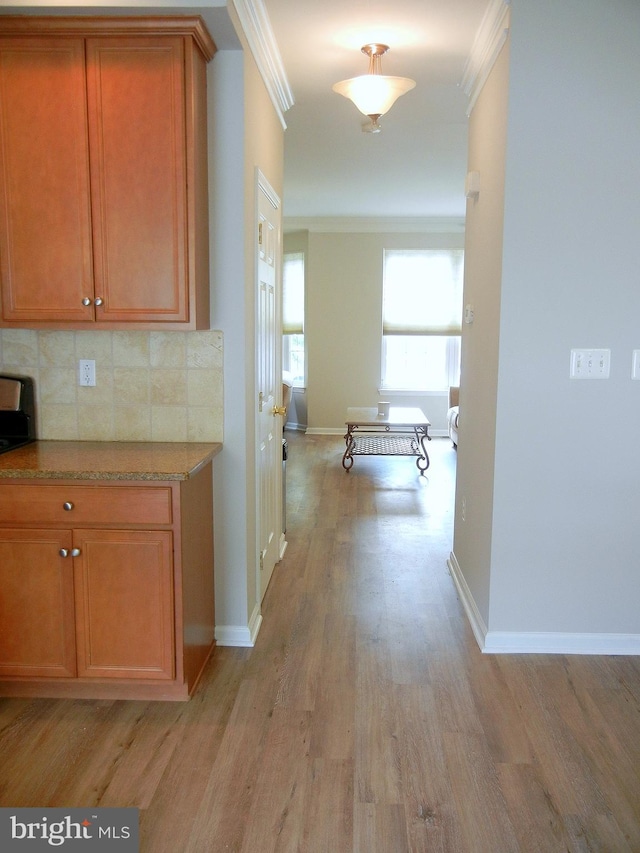 interior space featuring light wood-type flooring and crown molding