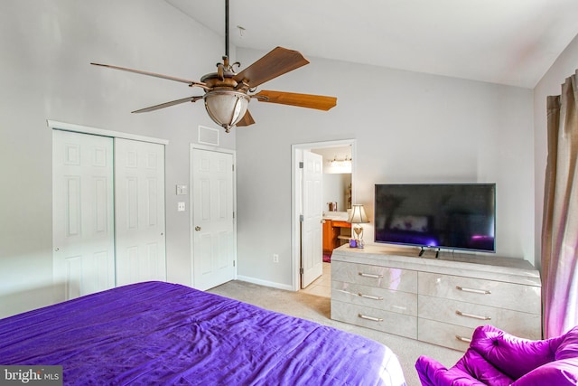 bedroom with light carpet, a closet, vaulted ceiling, and ceiling fan