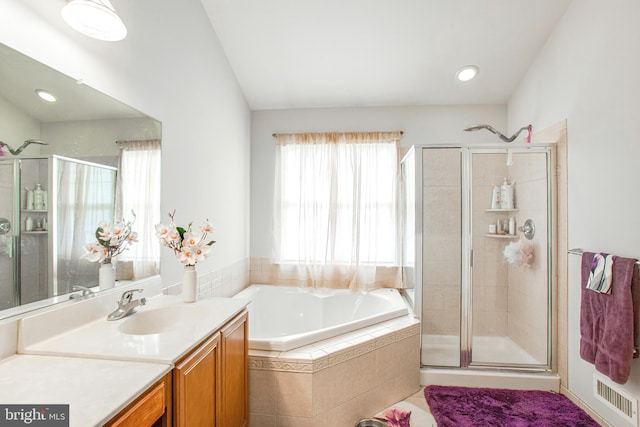 bathroom featuring vanity and separate shower and tub