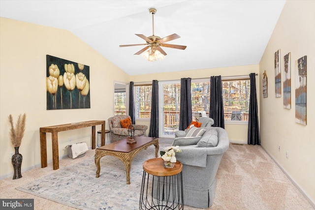 carpeted living room with ceiling fan and lofted ceiling