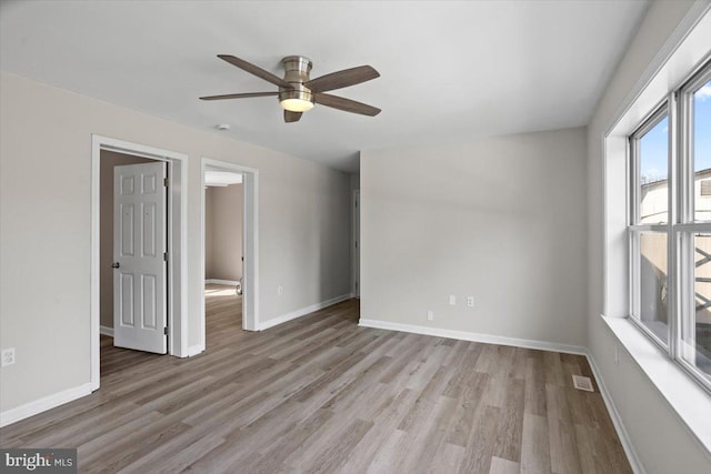 unfurnished room featuring ceiling fan and light wood-type flooring