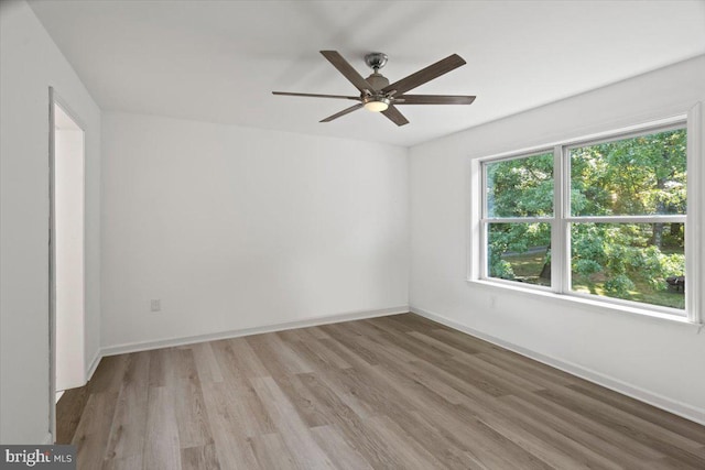 unfurnished room with ceiling fan and light hardwood / wood-style floors