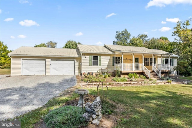 ranch-style house featuring a garage, a front yard, and covered porch