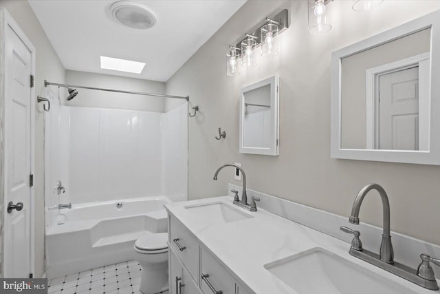 full bathroom featuring shower / washtub combination, vanity, toilet, and a skylight