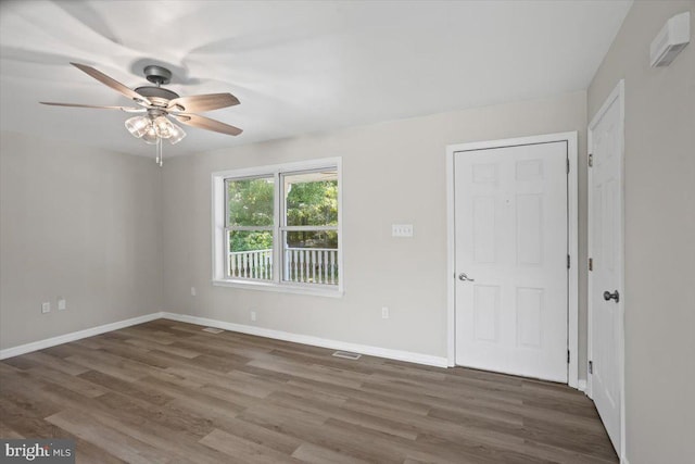 spare room with ceiling fan and dark hardwood / wood-style floors