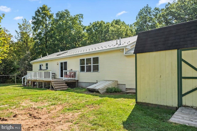 rear view of house featuring a yard and a deck