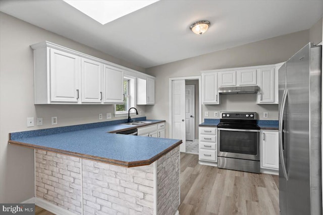 kitchen with lofted ceiling, white cabinetry, kitchen peninsula, light hardwood / wood-style flooring, and appliances with stainless steel finishes