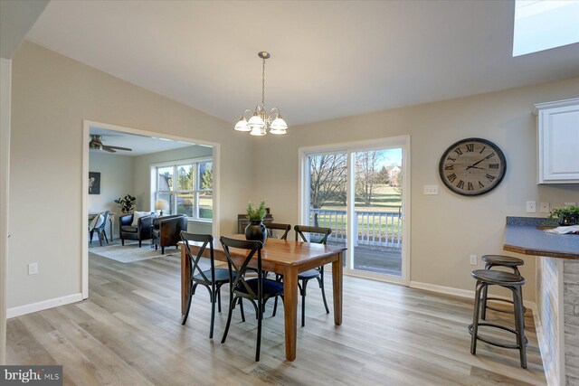 kitchen featuring black electric range, stainless steel refrigerator with ice dispenser, and white cabinetry