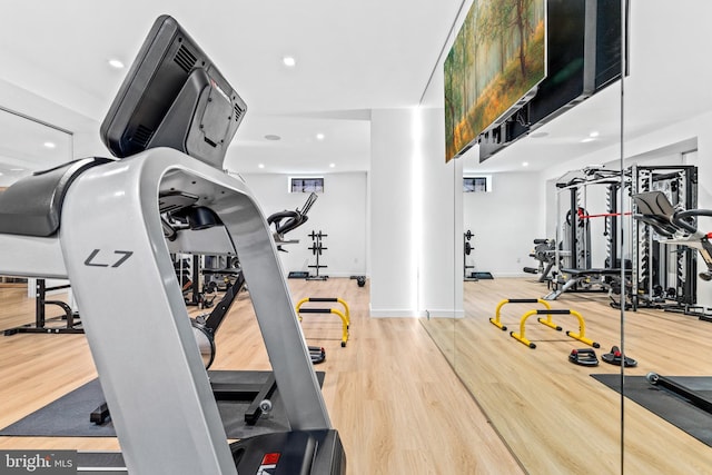 workout area with hardwood / wood-style flooring