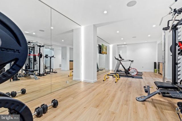 workout room with light hardwood / wood-style floors