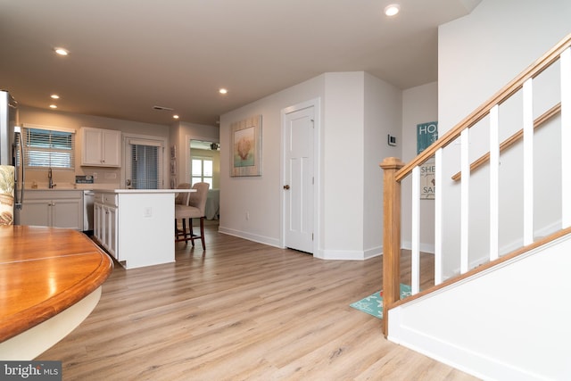 interior space featuring sink and light wood-type flooring