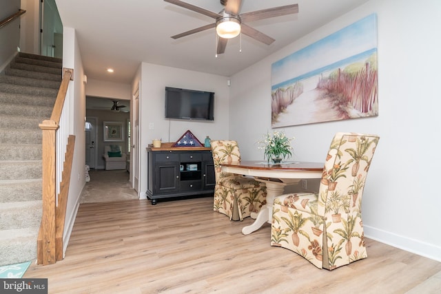 dining area featuring light wood-type flooring and ceiling fan