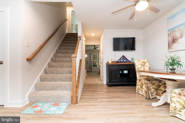 staircase featuring hardwood / wood-style flooring and ceiling fan