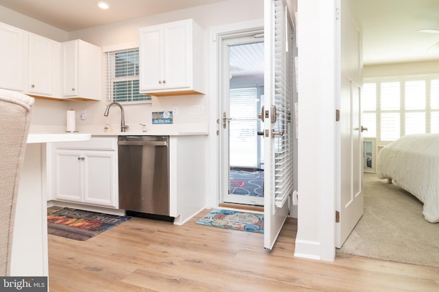 kitchen with dishwasher, light hardwood / wood-style flooring, and plenty of natural light