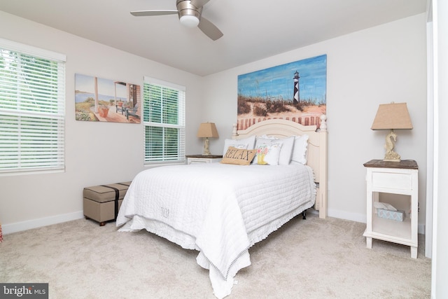 bedroom featuring light carpet and ceiling fan