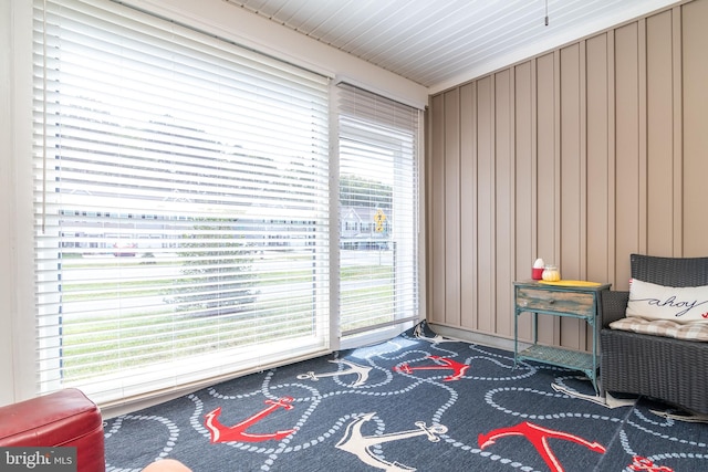 sitting room featuring wooden walls