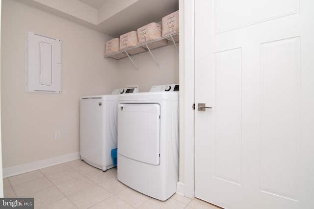 laundry area featuring light tile patterned flooring, electric panel, and washer and dryer