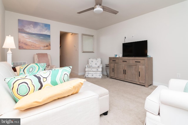 carpeted living room featuring ceiling fan